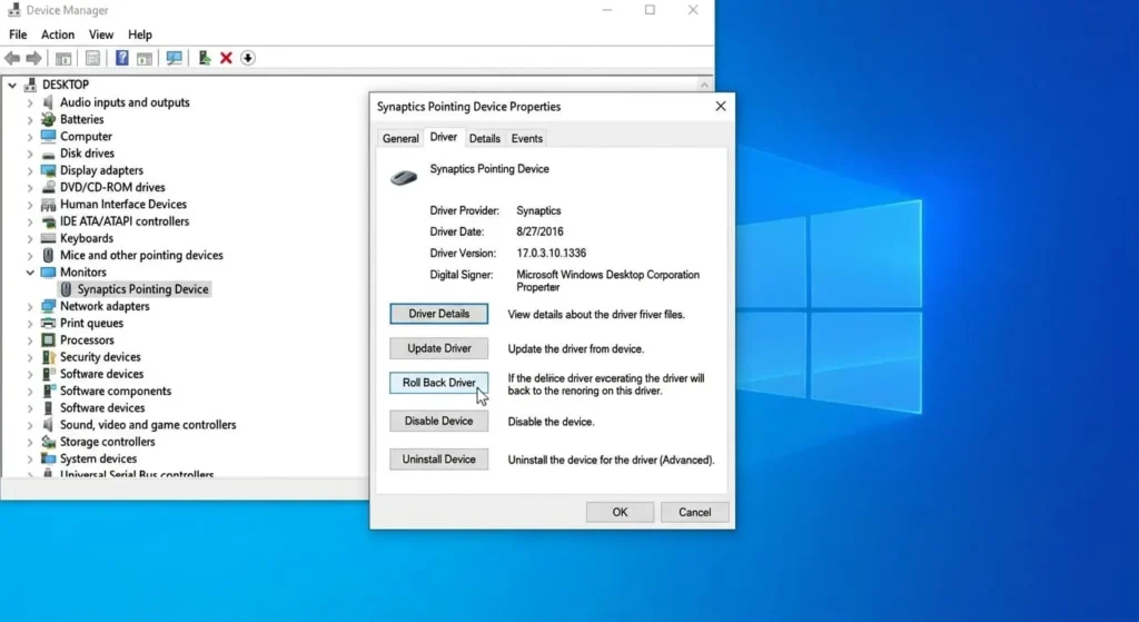 Screenshot of the Windows Device Manager and the driver properties window for a Synaptics touchpad. The "Driver" tab is selected, and a mouse cursor hovers over the active "Roll Back Driver" button.